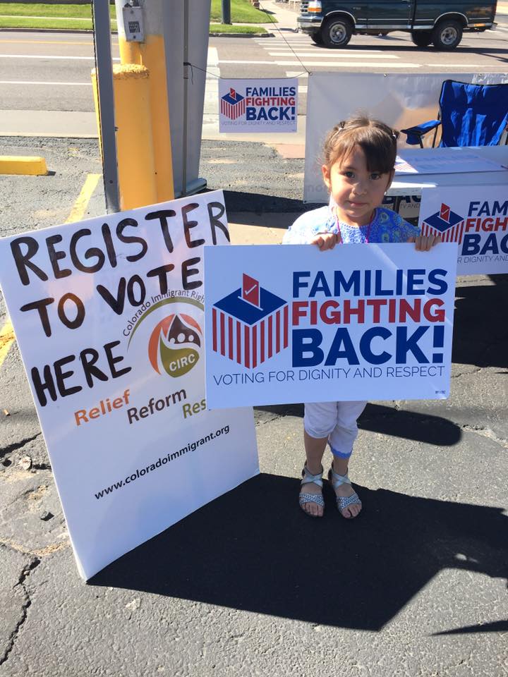 Kid with "families fighting back" protest sign